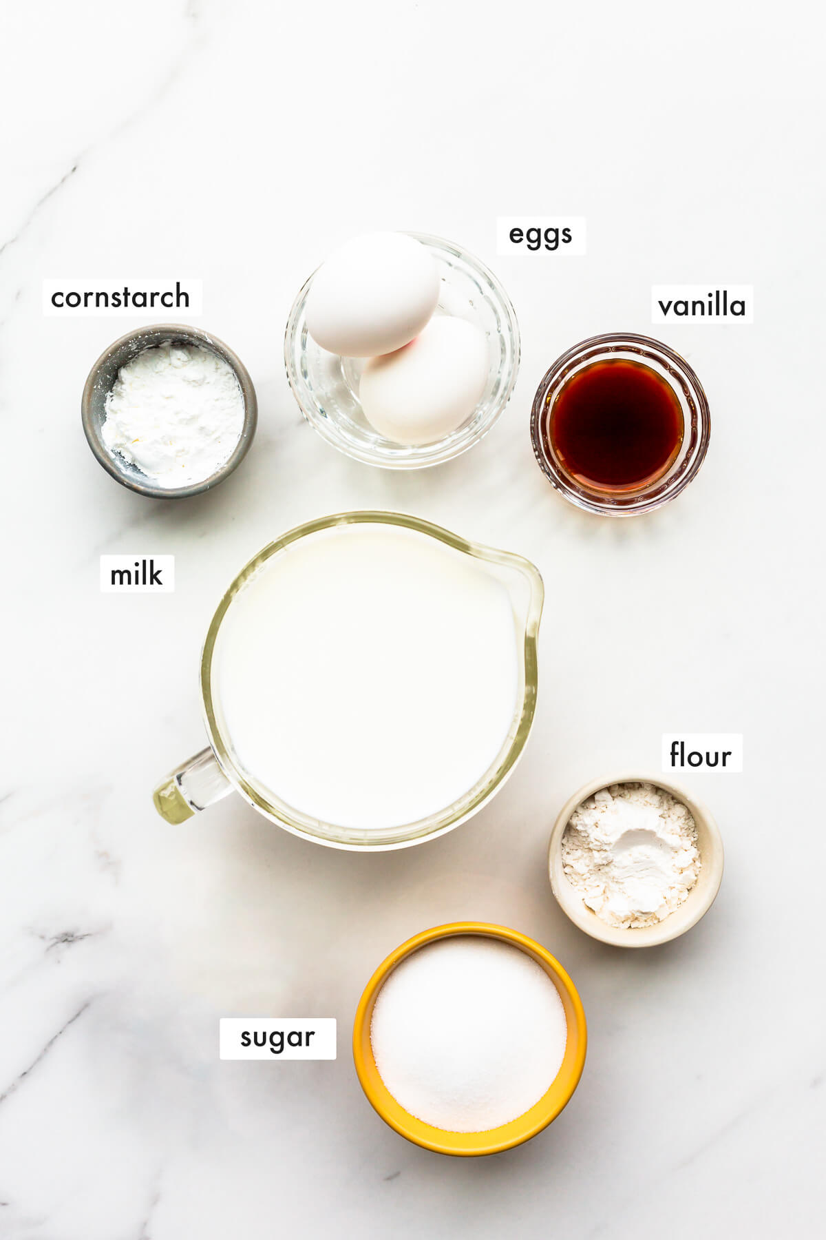 Ingredients to make pastry cream from scratch measured out and ready to use.