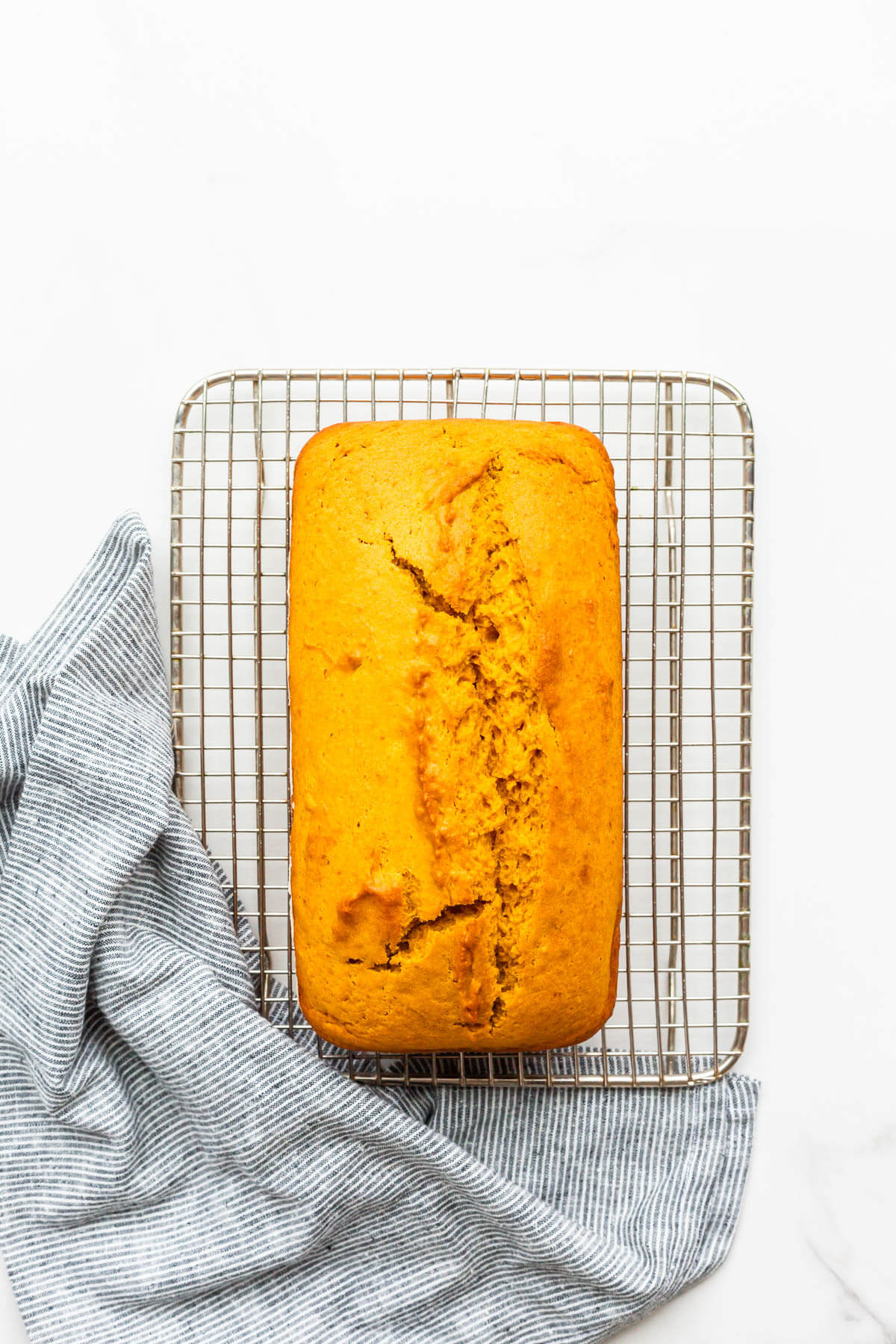 Pumpkin bread on a cooling rack.