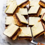 A platter of reversed Nanaimo bars with a chocolate custard filling and a white chocolate topping.