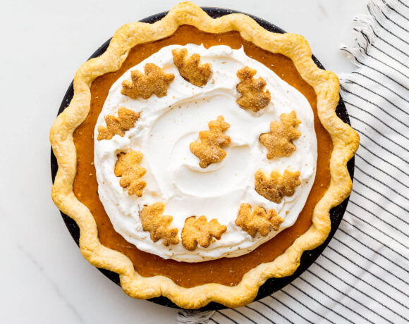 Sweet potato pie topped with whipped cream and grated nutmeg.