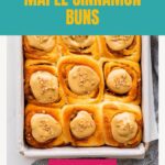 A pan of twelve maple cinnamon buns topped with maple butter.