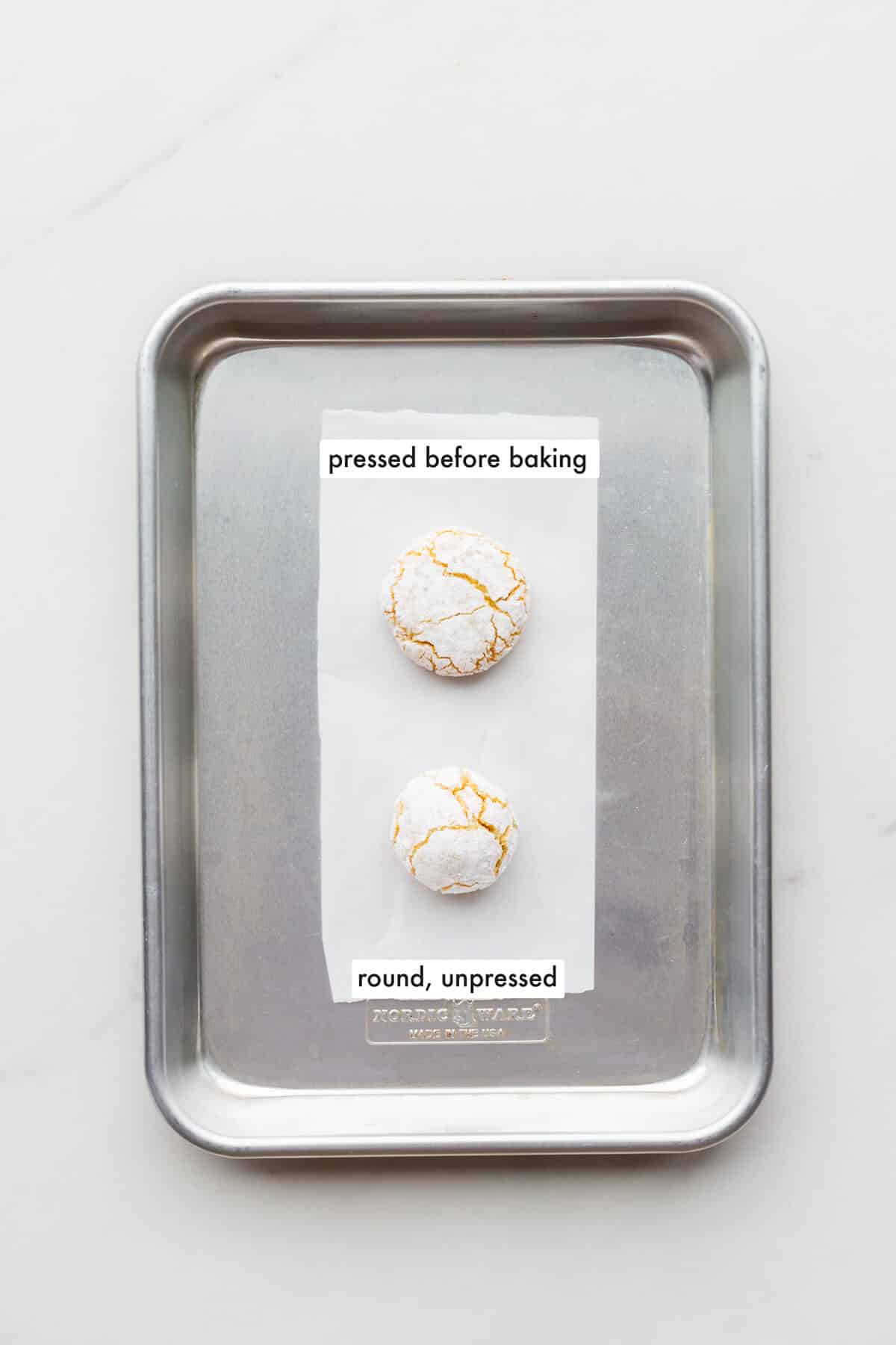 Comparing an amaretti cookie that was pressed down to flatten it before baking with an amaretti that was left round before baking to show how they turn out.