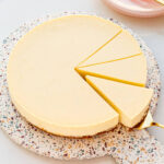 Slicing and serving a perfect baked vanilla cheesecake.