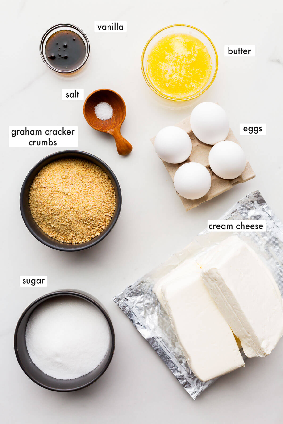 Ingredients to bake a cheesecake measured out.