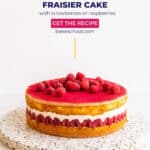 A framboisier cake (like a fraisier with raspberries instead of strawberries) with layers of sponge cake, fresh berries, and mousseline cream topped with marzipan, set on a terrazzo board.