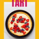 A custard tart garnished with fresh berries.