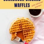 Homemade waffle served with maple syrup.