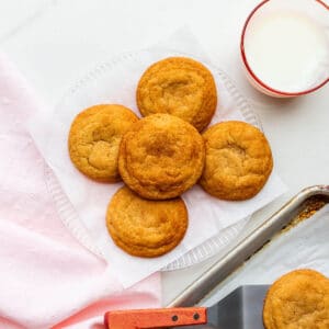 A plate of freshly-baked homemade snickerdoodles transferred from the cookie sheet with a spatula.