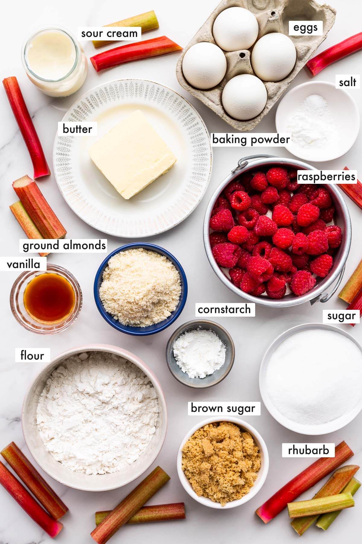 Ingredients to make a rhubarb upside-down cake with raspberries.