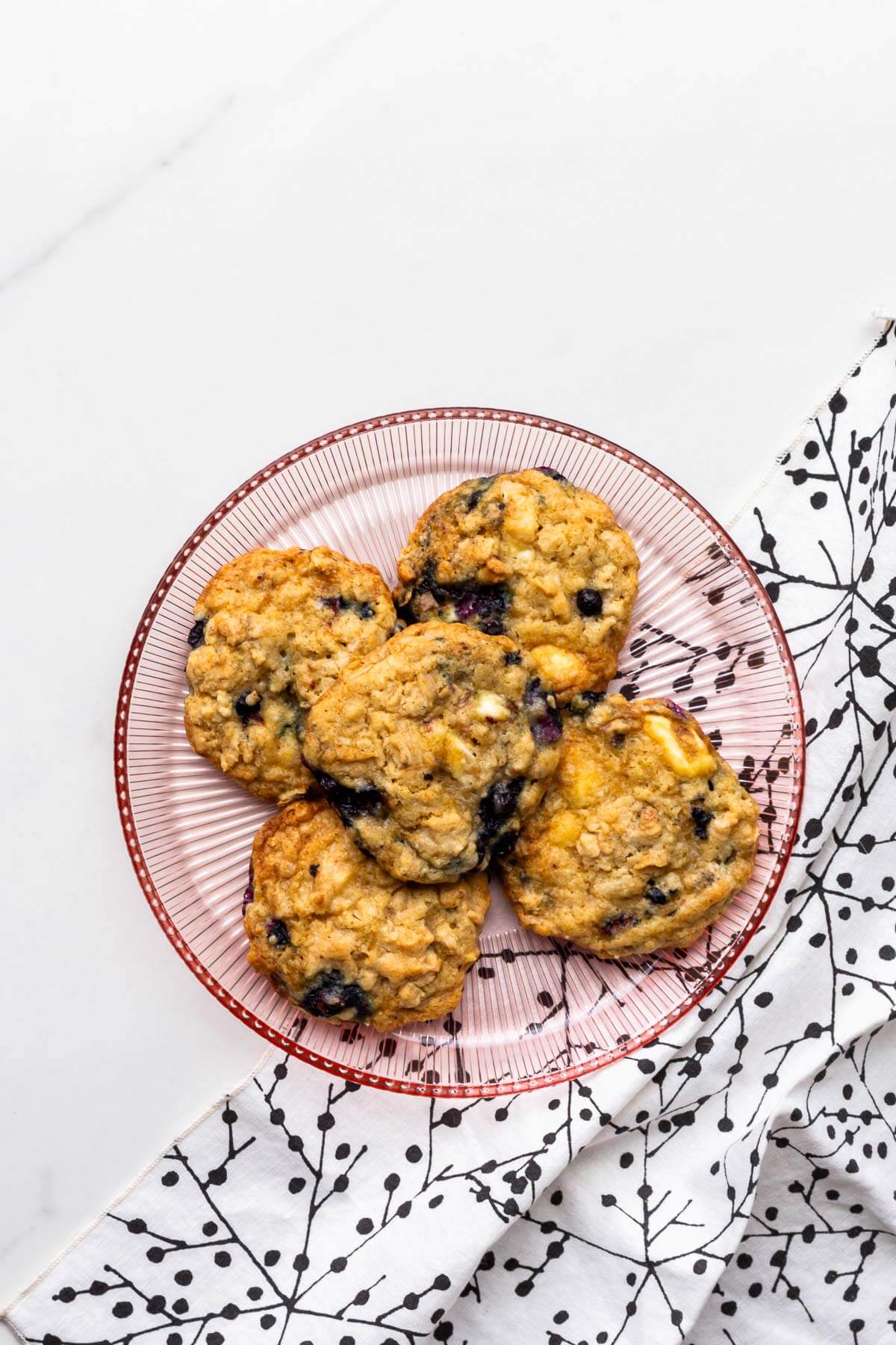 A plate of blueberry oat cookies with white chocolate.