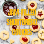 Assembling jam-filled shortbread cookies by sandwiching two cookies with a dollop of jam.
