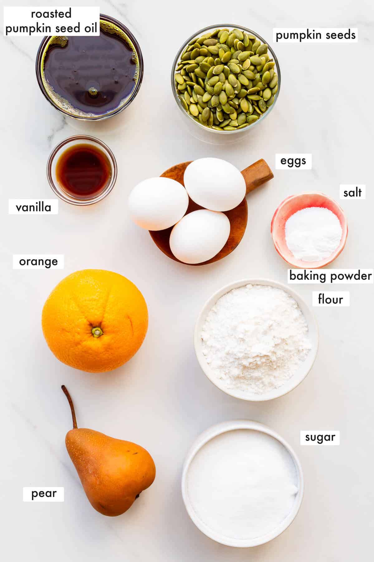 Ingredients to make a pumpkin seed cake with roasted pumpkin seed oil, measured out and ready to be mixed.