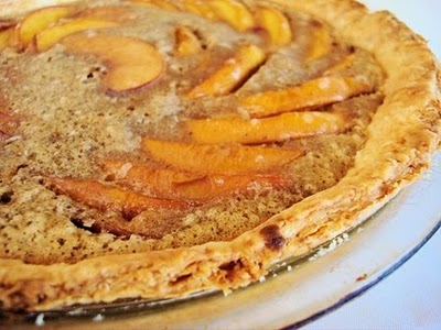 Peach custard pie in a glass pie plate